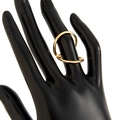 Detail view of interlocking double-loop gold metal bracelet with a wavy spring design - Double Loop Intertwined Ring (0823) / Gold