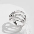 Macro detail of silver ring featuring a layered wavy hollow design on a white stone base - Three Layer Oval Line (0822) / Silver Ring