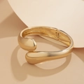 Close-up of polished gold-plated stackable bangle featuring a sleek teardrop design - 03 Gold Bangle (2427) / Gold