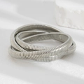Macro shot of silver multi-layered spiral coil bracelet with textured metallic finish - 03 Three Layer Spiral Elastic Bangle (2763) / Silver