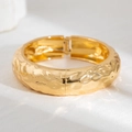 Macro shot of gold wide hammered metal cuff bracelet with geometric liquid texture - Gold (2543)