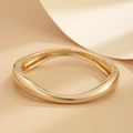 Close-up of polished gold-tone wavy bangle with asymmetrical design and hinge mechanism - Gold Bangle (2430)