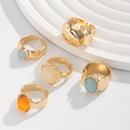 Detailed close-up of adjustable vintage gold rings set with blue and amber acrylic stones - Ring Set / Gold (5803E1)