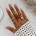 Detail shot of bohemian gold alloy rings set with vibrant acrylic stones and textured finish - Ring Set / Gold (6262)