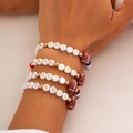Close-up of four layered American football beaded bracelets with sports letter charms - 05 Multicolor Set (5817)