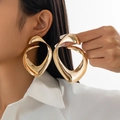 Close-up of oversized golden irregular spiral earrings with high-polish metallic finish - Irregular Spiral (3491) / Gold (3491)