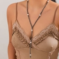 Detailed view of bohemian Y-shaped long necklace with grey beads and white pearls on a model - Artificial Pearl Decor (7018)
