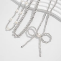 Bohemian style necklace with white faux pearls and a metallic bow pendant charm - Silver
