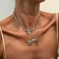 Detail of layered silver bow necklaces on model showing multi-strand choker pendants - White K Butterfly Multilayer Set (5977)