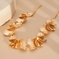 Detail of gold metal flower necklace with textured petals and lobster clasp closure - Gold