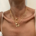 Layered gold heart pendant necklace with ribbon bow and faux pearl details on model - Gold Heart Multilayer Set (6026)