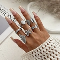 Close-up of bohemian silver starfish and seashell ring set on model's hand - Silver Vintage Ocean Theme Style