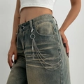 Detail of multi-layer silver metal waist chain with cross pendant on denim jeans - Triple Layer Cross Style (1787)