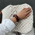 Close-up of deep red resin cuff bracelet styled with casual French retro aesthetic - Bangle / Red