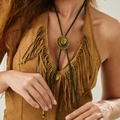 Retro cowboy hat bolo tie with black braided cord and antique bronze pendant on a model - Black and Bronze (7327)