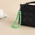 Detail of light green acrylic beaded bag charm with silver metal spring lobster clasp - White Gold Plated Green