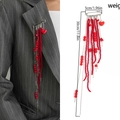 Broche cœur à franges rouges sur costume gris avec dimensions détaillées - Gland Rouge (0364)