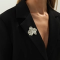 Spilla a cigno in argento liquido plissettato su bavero di abito nero con finitura lucida - Petali Irregolari (0339) / Argento