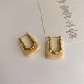 Close-up of geometric U-shape gold metal earrings with marble texture resin inlay - Beige Square
