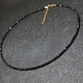Elegant black faceted crystal choker necklace with adjustable gold-tone clasp - Black
