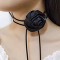 Detail of a large 3D black satin silk rose flower choker with long adjustable ribbon ties - Black