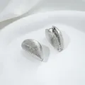 Detailed view of silver shell-textured hoop earrings on a white minimalist display tray - 6# White Gold 17x26x15mm
