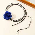 Detailed view of the handcrafted deep blue satin rose on a thin black velvet choker string - Blue