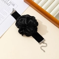 Detail of a large black handmade flower choker with soft velvet ribbon and adjustable clasp - Wrist Corsage / Black