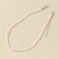 Elegant multi-faceted glass crystal necklace with silver lobster clasp on beige surface - Silver