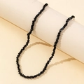 Elegant black beaded necklace with faceted crystals and silver clasp on beige base - Black