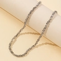 Minimalist smoky grey faceted beaded necklace wrapped on a beige pillar stand - Gray