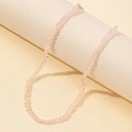 Macro view of light pink faceted glass beaded necklace with fine silver metal clasp - Pink