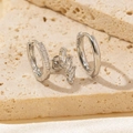 Detail of silver earrings set featuring marquise-cut stones on travertine surface - Style 2 / Silver