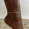 Flat gold snake chain anklet for women on a sandy beach with shell decorations - Gold Flat Curb Chain (JC-131G)