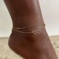 Double-layer gold stainless steel anklet with hollow heart charms on a beach setting - Gold Double Layer Hollow Heart Chain (JC-125G)