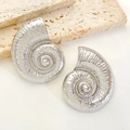 Detailed macro view of silver conch earrings with embossed spiral relief on travertine - Silver Conch Stud Earrings (3954)