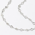 Close-up of heart-shaped links and sparkling zircons on a silver fringe necklace - Silver Bracelet