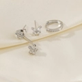 Close-up of asymmetric star and moon earrings set with zircons on silk fabric - Butterfly Flower Style - Silver (2)