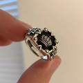 Macro view of vintage silver crown ring with black square base and side cross embossing - 3D Crown and Cross (182)