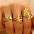 Detail of gold starfish and shell rings on hand for summer ocean beach style jewelry - Ocean Natural Combo Style (08) / Set of 3 / Gold