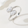 Macro detail of silver adjustable cuff bracelet featuring two baroque pearls at the ends - Bangle Silver