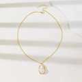 Elegant gold baroque pearl pendant necklace with irregular metal edging on white surface - Golden Necklace