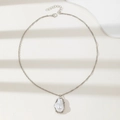 Elegant irregular faux pearl pendant necklace with silver metal chain on ivory background - Silver Necklace