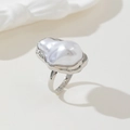 Macro detail of silver baroque pearl ring on a warm beige background with silk ribbon - Ring Silver