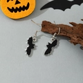 Close-up of black bat dangle earrings hanging on rustic wood for Halloween decor - Black Bat Ear Hook