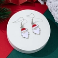 Detail shot of Santa Claus earrings with red and white enamel on a festive backdrop - Santa Face Style (9)