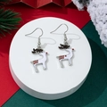 Close-up of white reindeer Christmas earrings with red dots on a festive display - White Reindeer Style (17)
