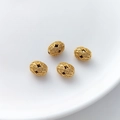 Macro detail of four gold hollow oval beads with vintage embossed floral patterns - Oval Hollow Bead (1#) / 1 Piece (7.5x9.8mm)