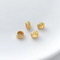 Detail view of four matte gold cylinder beads with embossed floral patterns for jewelry - Clover Cylindrical Style (3#) / 1 Piece (3x5.5mm)
