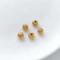 Detailed view of five hollow gold-plated filigree spacer beads on white ceramic - Scroll Pattern Hollow Ball (4#) / 1 Piece (5x5.5mm)